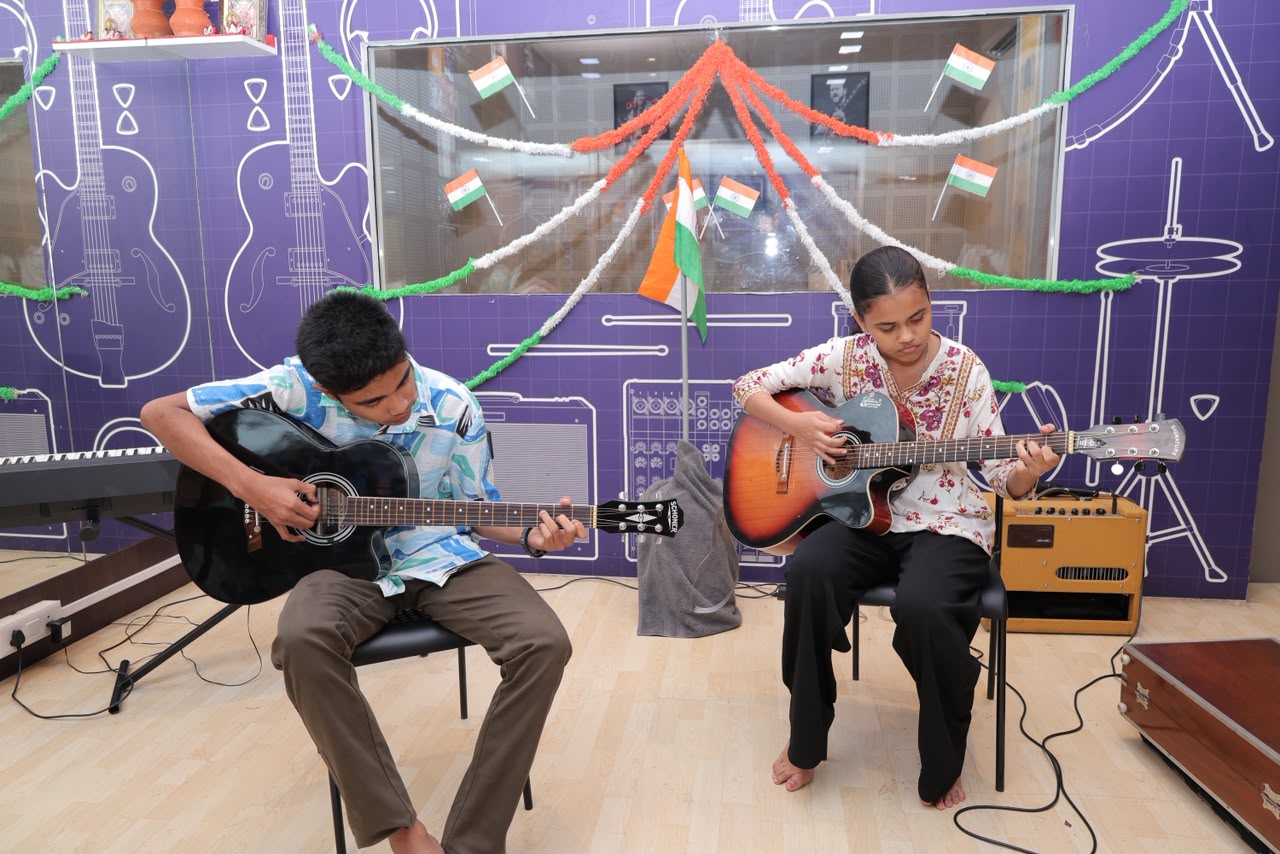 Skylark students playing guitar