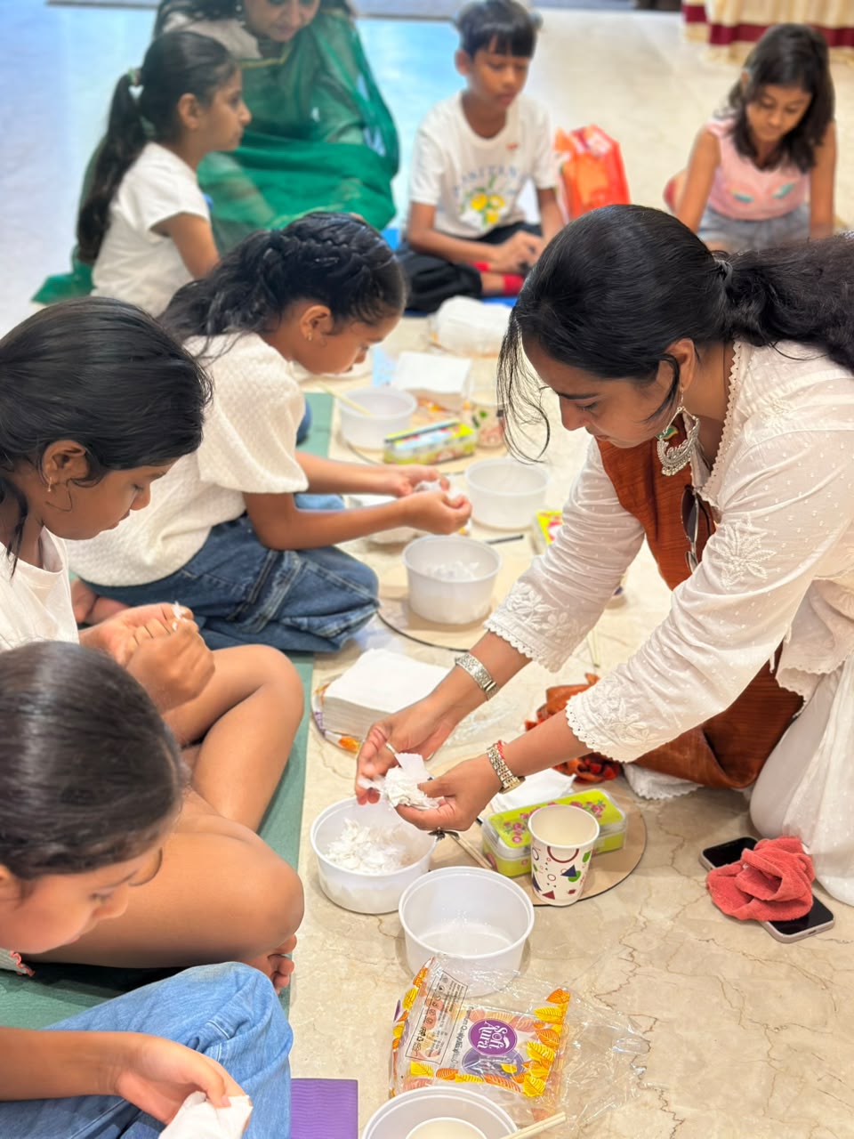 Skylark art faculty guiding children during a craft session